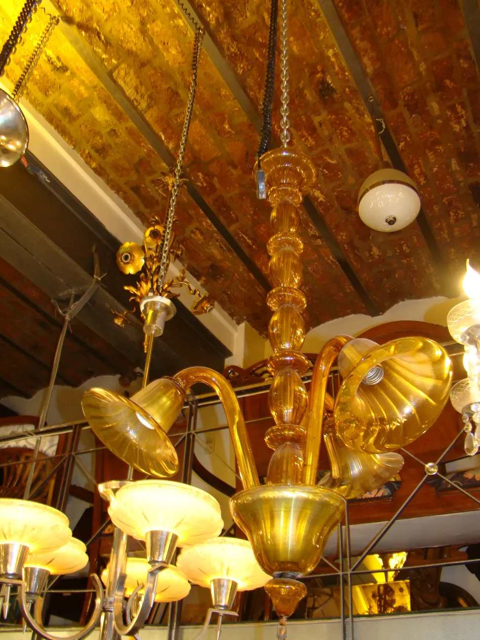 Antique hanging lamp with elegant arms in a classic setting