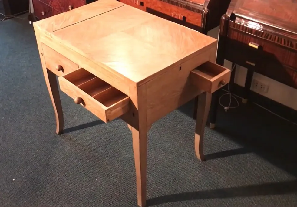 Antique wood desk with two visible drawers, set in a cozy environment.