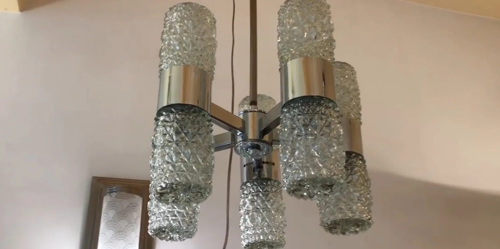 Antique hanging lamp with bright crystals in a modern setting.