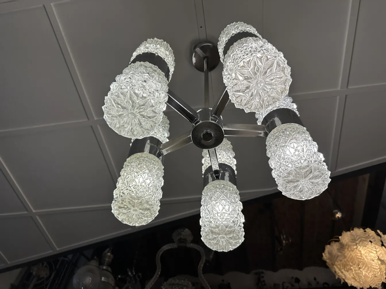 Antique hanging lamp with frosted glass shade, elegant setting.