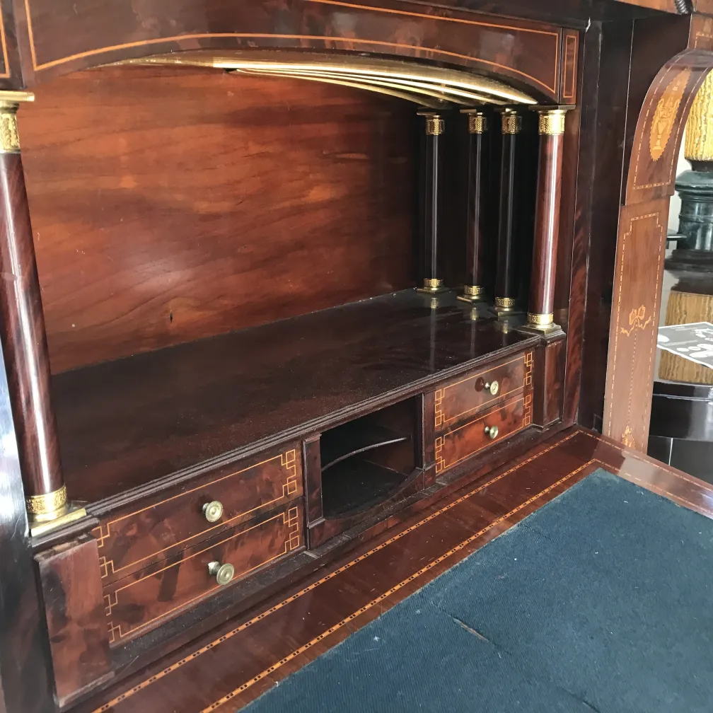 Antique desk featuring two drawers and a stylish backdrop.