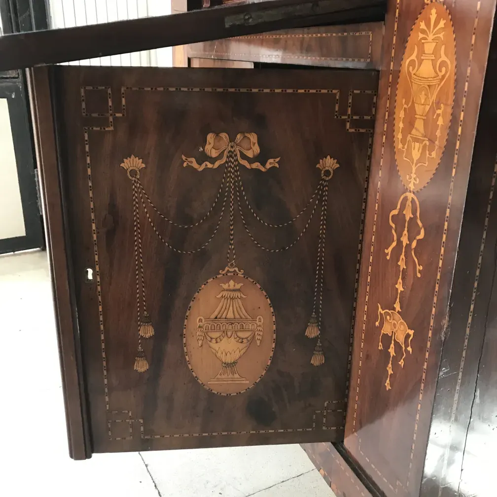 Antique desk with intricate artisan details on the surface.