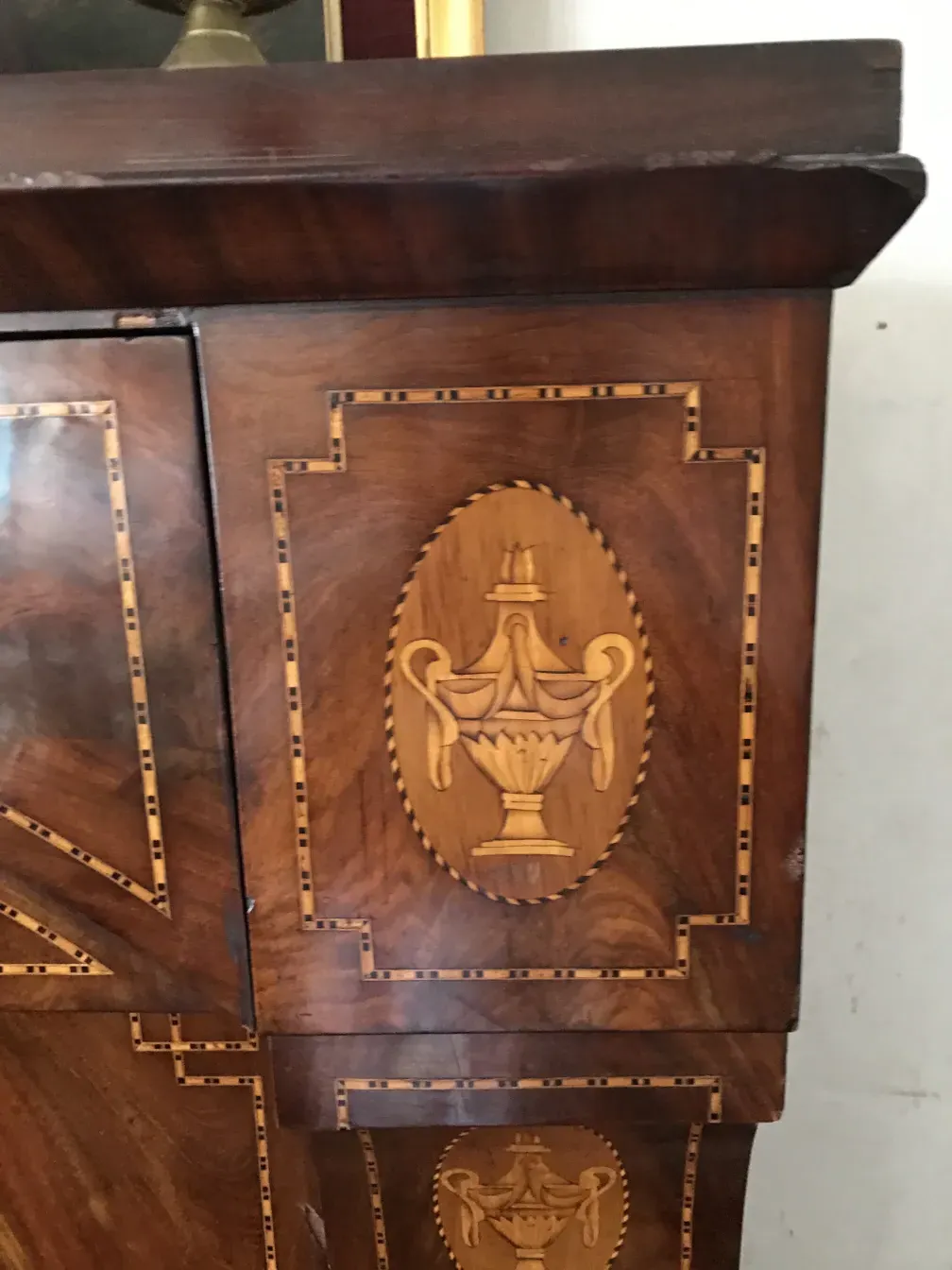Antique desk with intricate wooden design details.