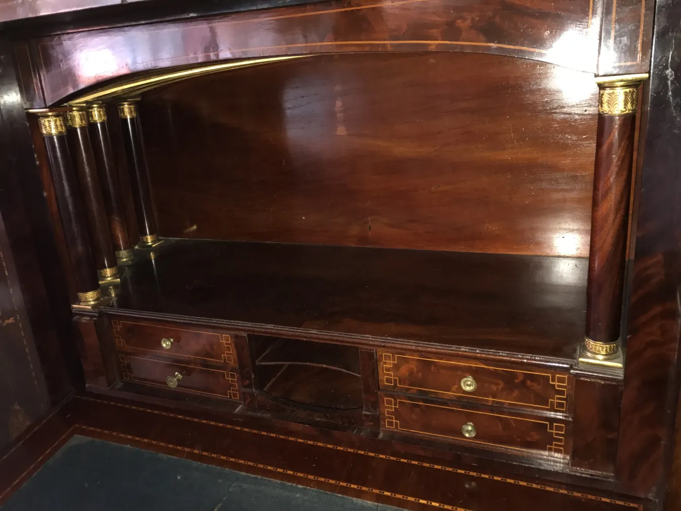bureau ancien avec des accents dorés et tiroirs