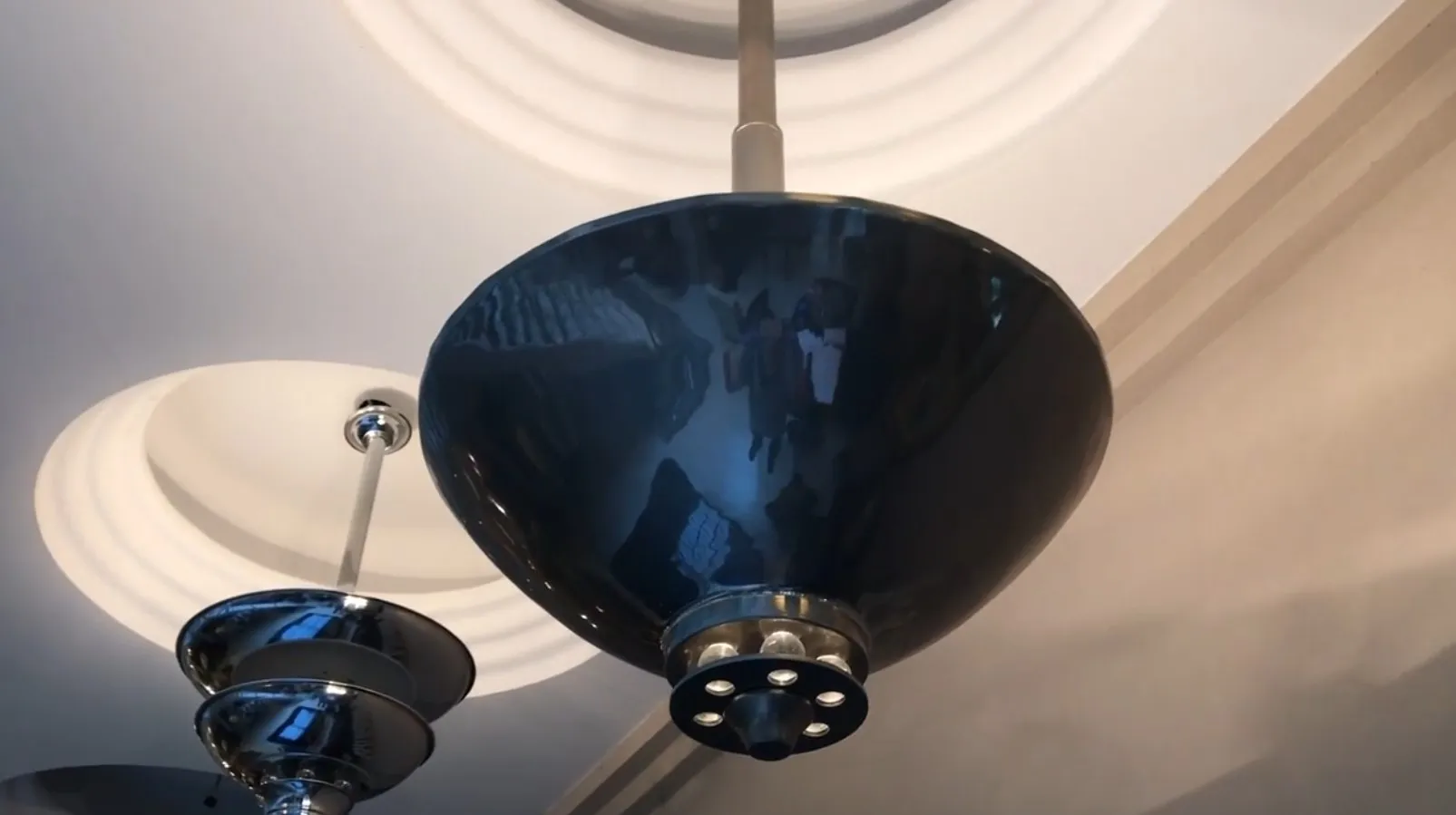 Antique hanging lamp with a shiny finish in a modern room.