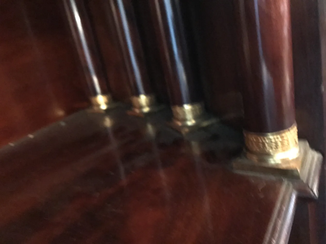 Antique desk featuring golden decor and pillars
