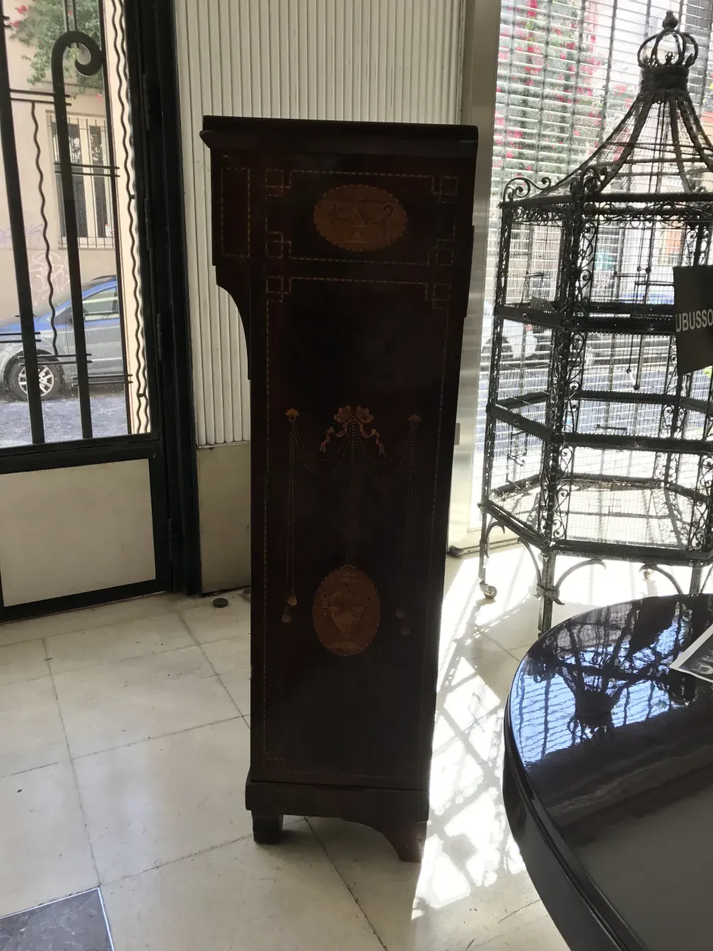 Antique desk with embossed details in a bright setting.