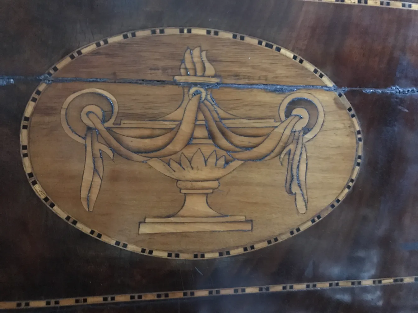 antique desk featuring ornate urn designs