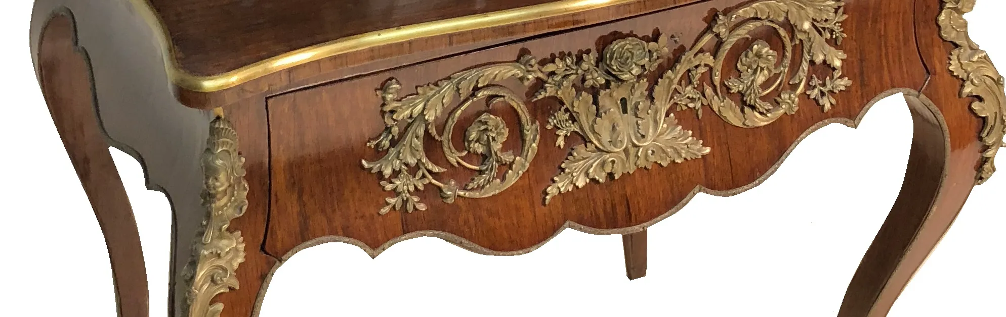 Antique desk with elegant golden decorations and intricate designs
