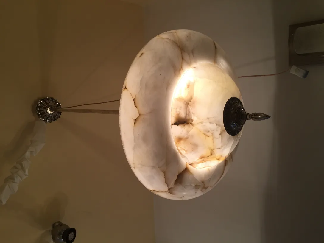 Antique hanging lamp in alabaster with a soft glow