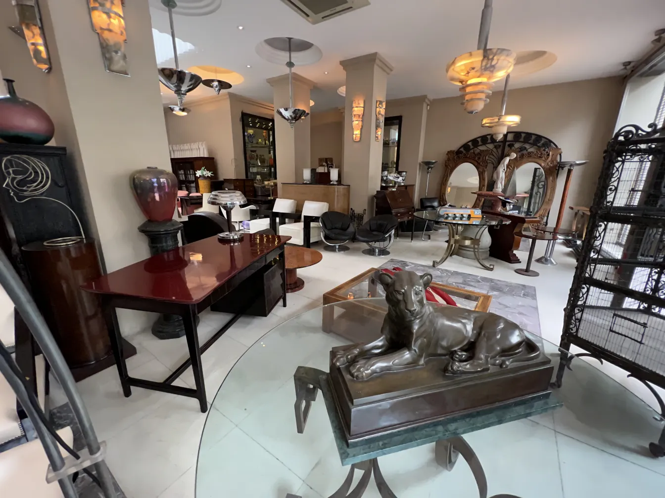 गहरे रंग की पुरानी डेस्क, चारों ओर शानदार फURNITURE से घिरी हुई।