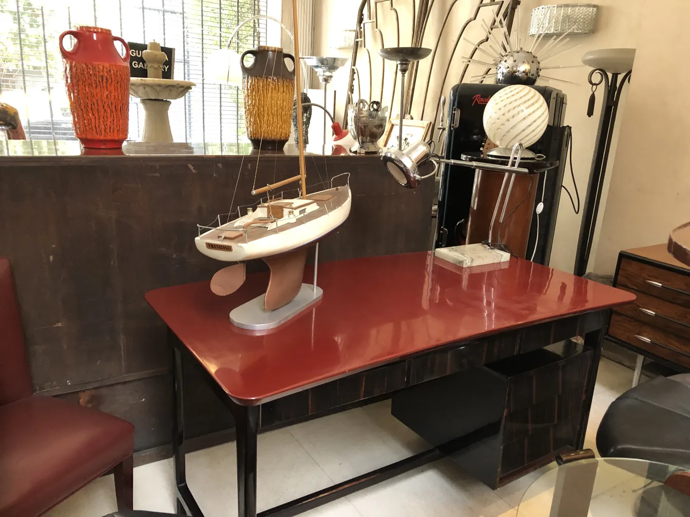 Antique desk with unique decor and a model boat.