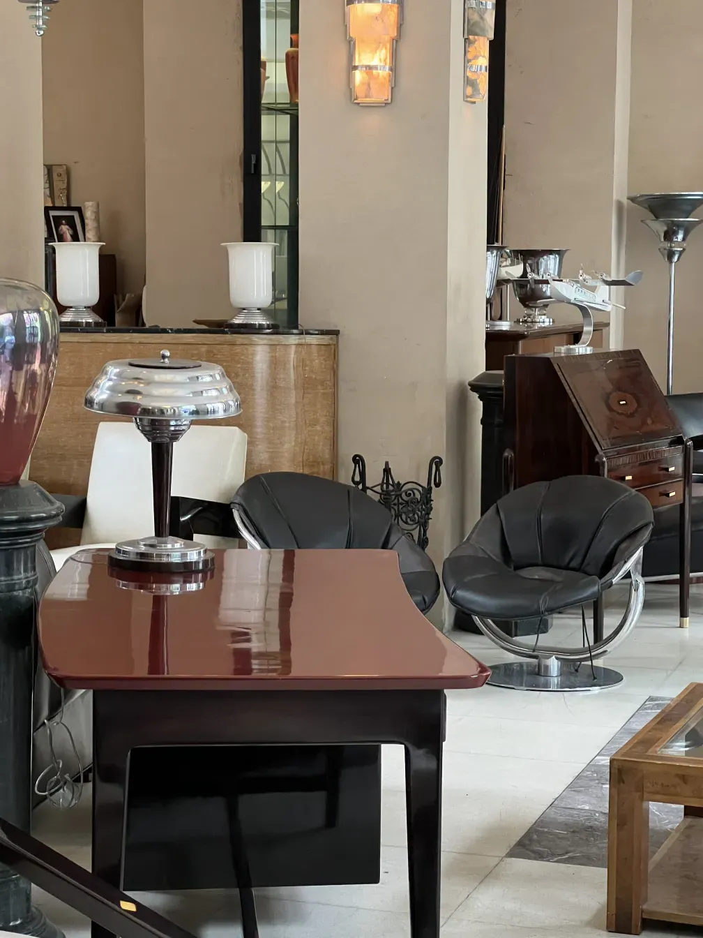 Antique desk with a shiny finish and decorative accessories in an elegant setting.