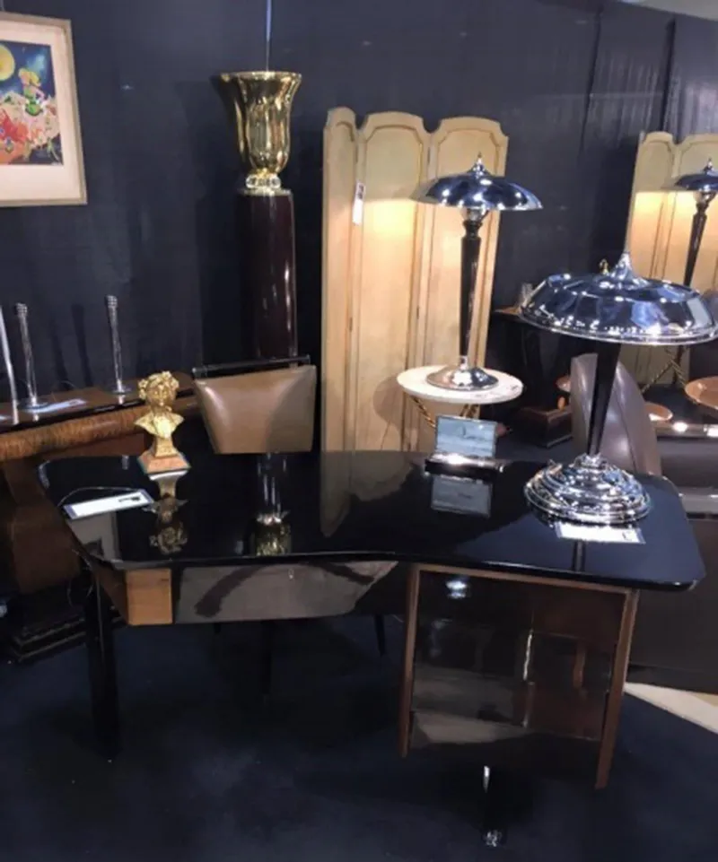 Elegant antique desk with shiny surface and decorative lamp