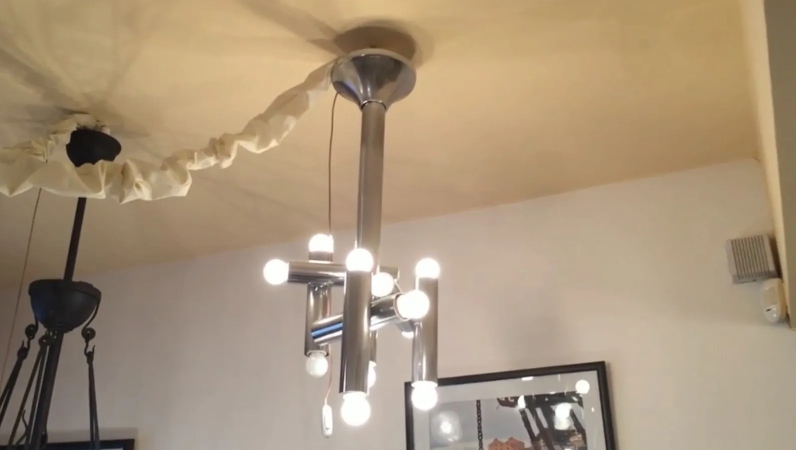 Antique hanging lamp with multiple bulbs illuminating the space