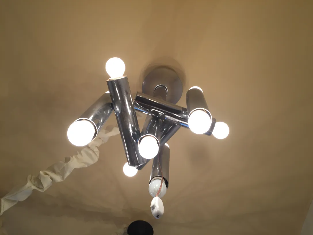 Antique hanging lamp featuring multiple bright bulbs, perfect for decoration.