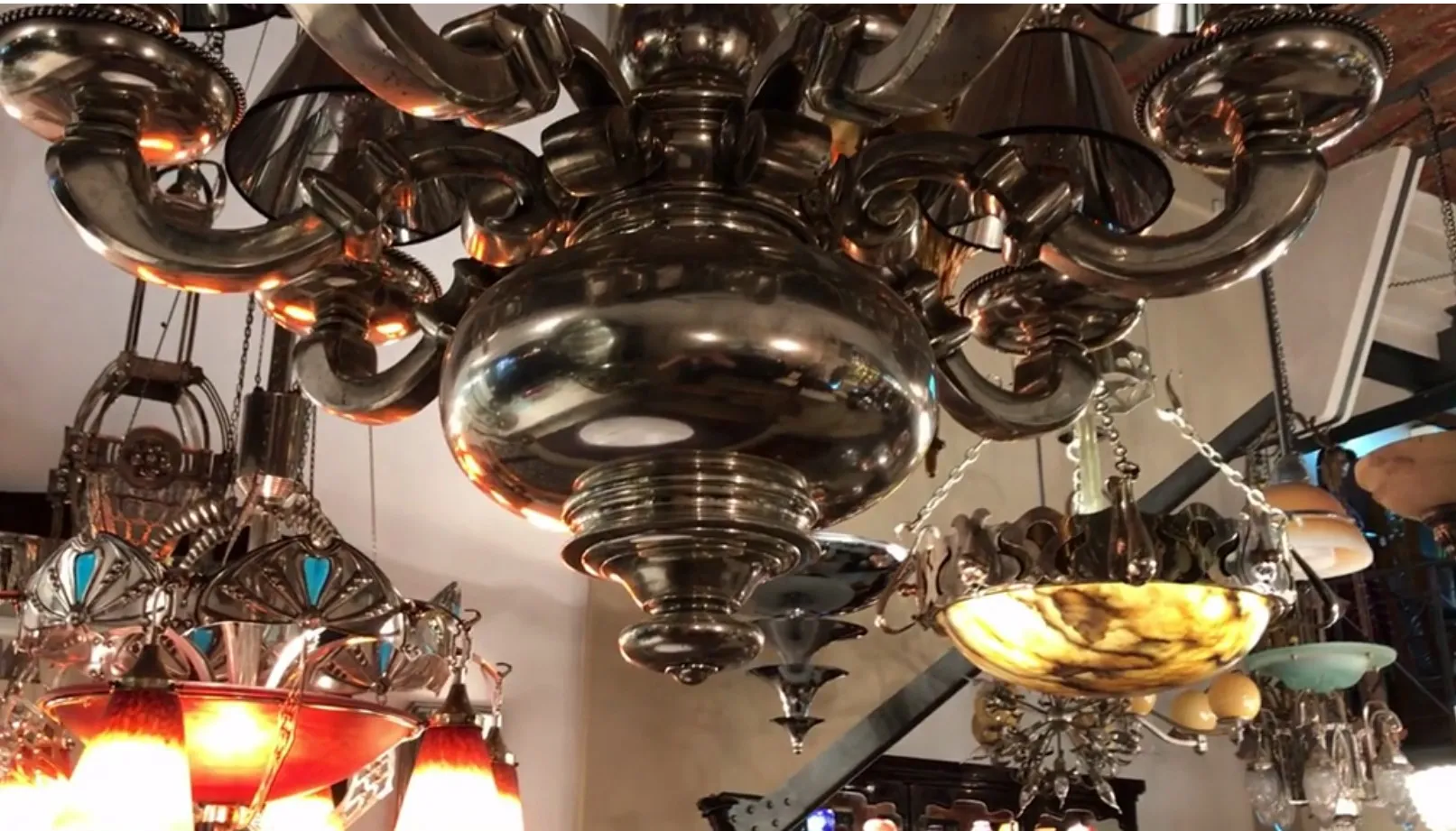 Shiny antique hanging lamp with decorative details. Cozy atmosphere with other lamps.