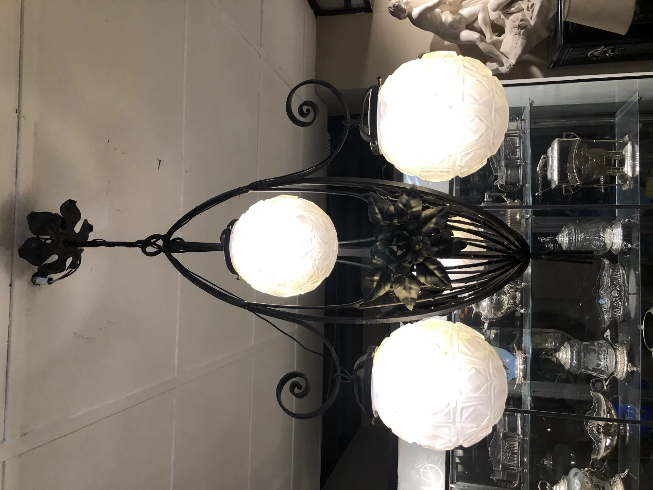 antique hanging lamp with three white spheres in an elegant setting