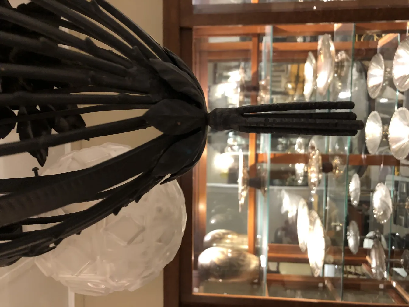 Antique hanging lamp with a unique design in a cozy setting.