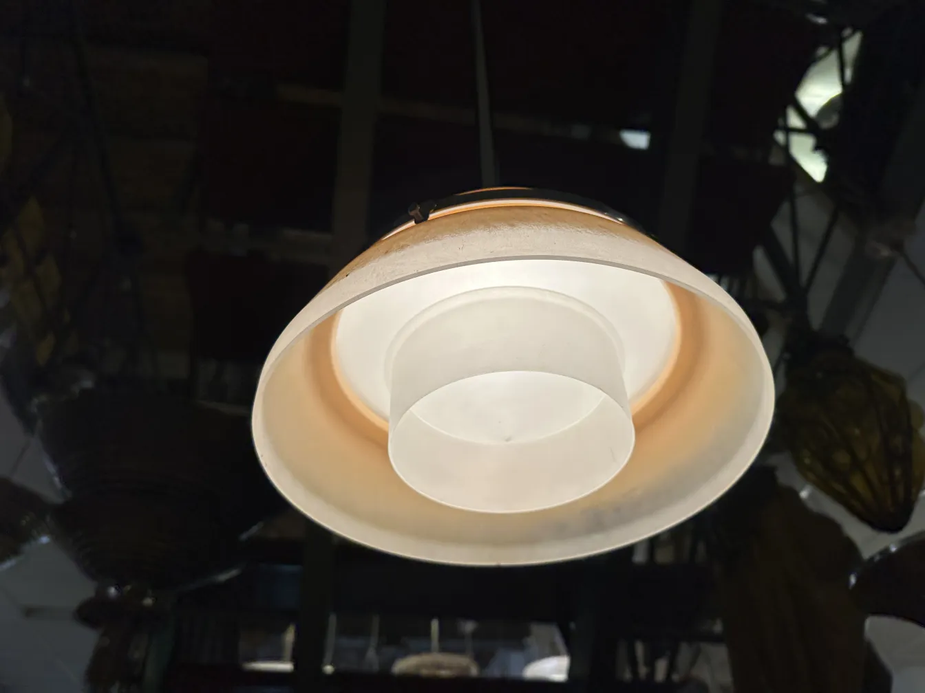 Antique hanging lamp with light tones design illuminating the space.