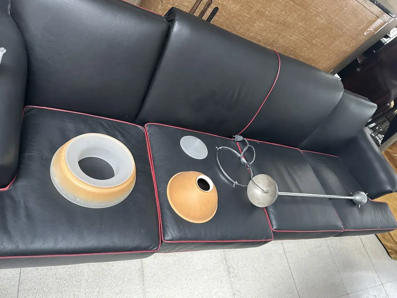 antique hanging lamp parts on a black couch