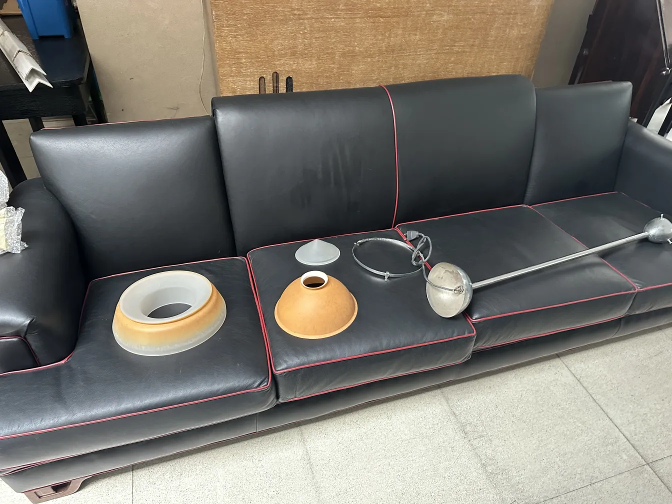 various parts of an antique hanging lamp on a couch