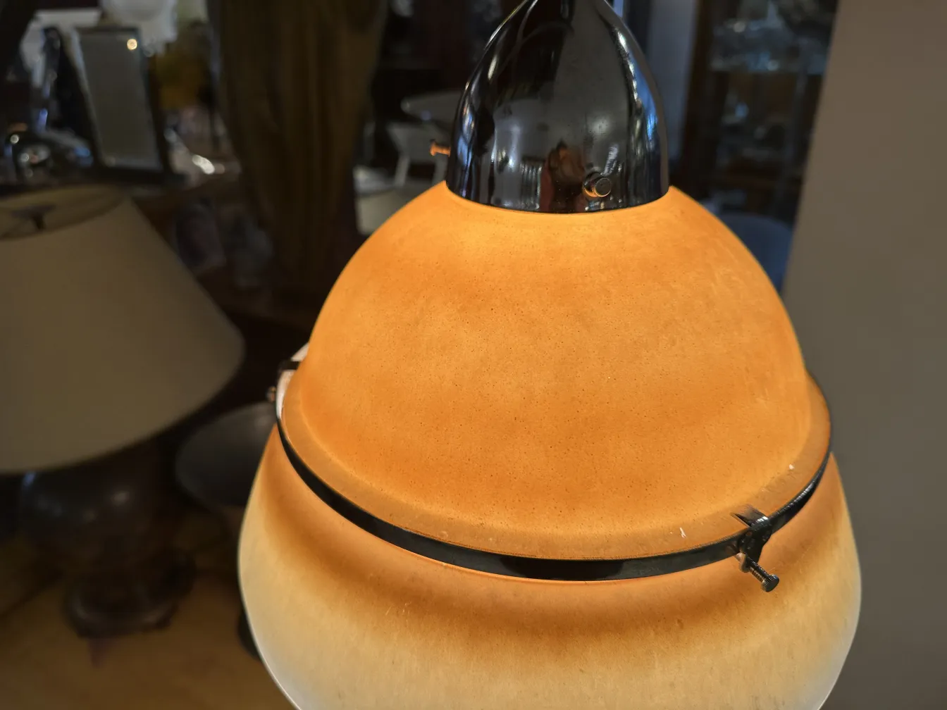 Antique hanging lamp with warm color and distinctive design in a cozy setting.