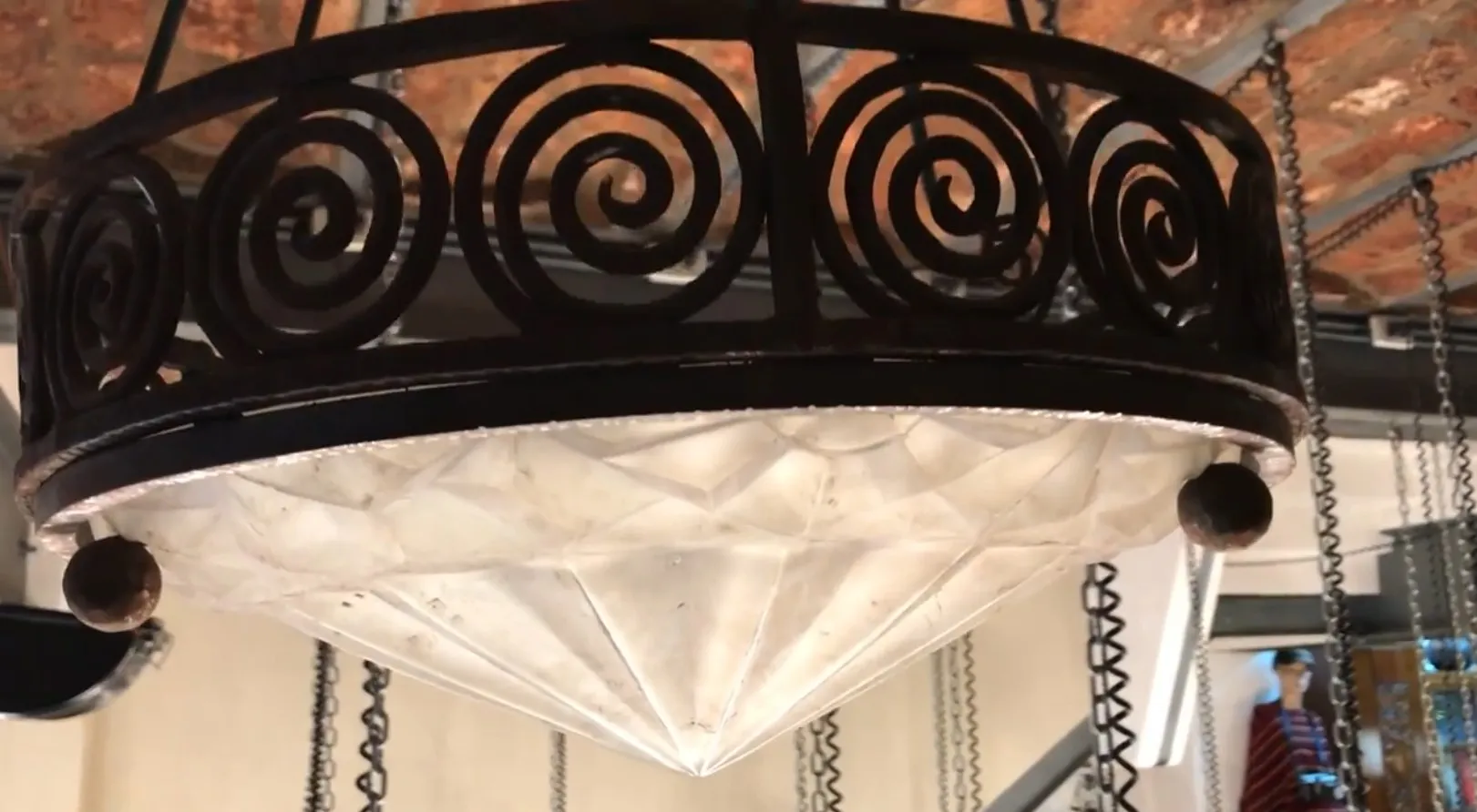 Antique hanging lamp with spiral design and crystal. Cozy environment.