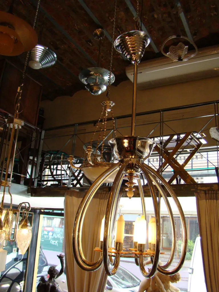 Antique hanging lamp with elegant arms and soft light.