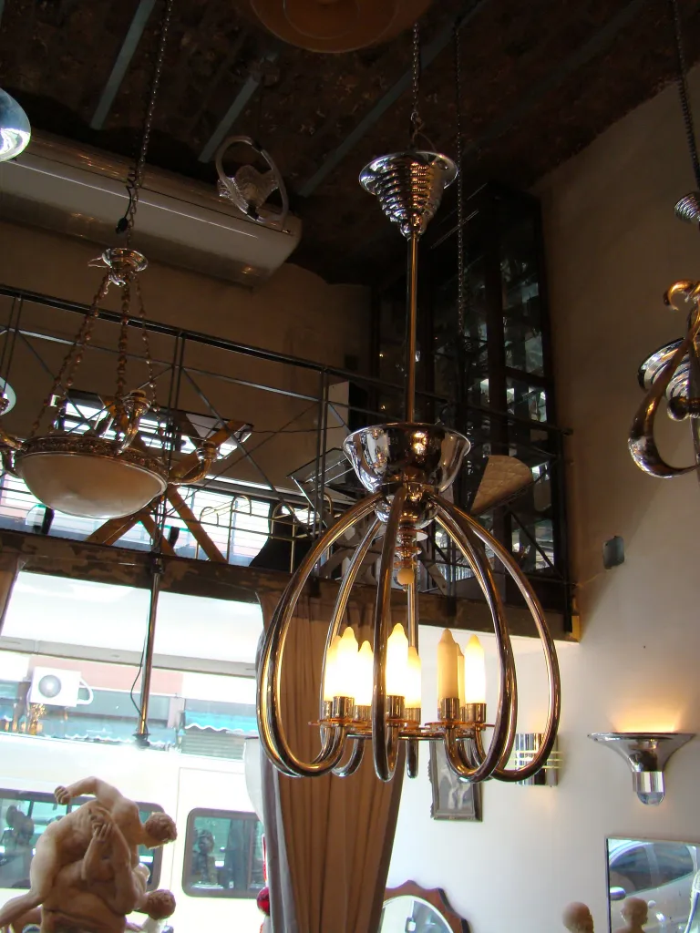 Antique hanging lamp with a sleek modern design in an artistic setting.