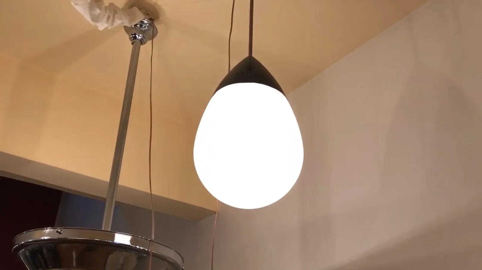 Antique hanging lamp with modern design, sleek white shade.