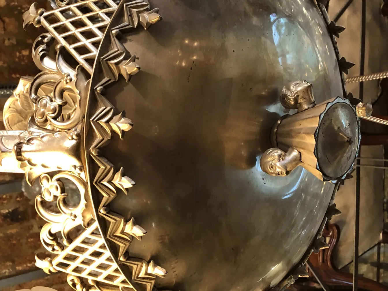 Lampada a sospensione antica con un design decorativo distintivo.