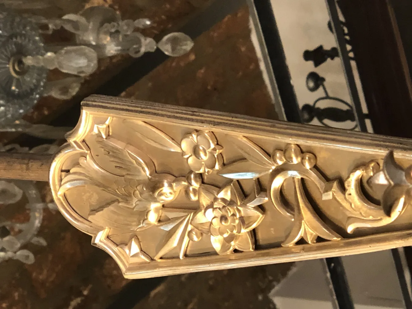 Antique hanging lamp with intricate floral details, warm ambiance.