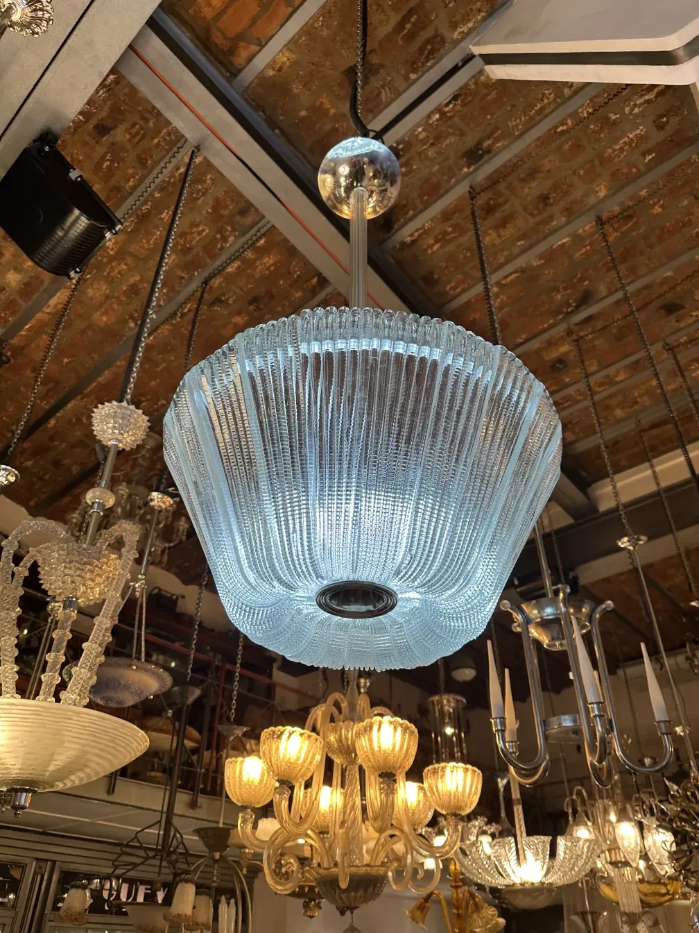 Antique hanging lamp with elegant design by Paolo Venini, illuminating a classic setting.