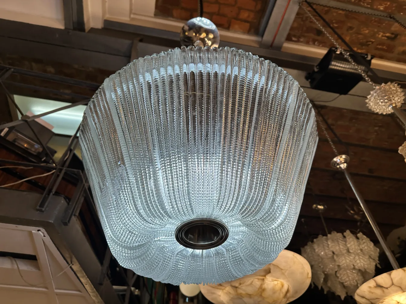 Antique hanging lamp with a translucent design in a modern setting.