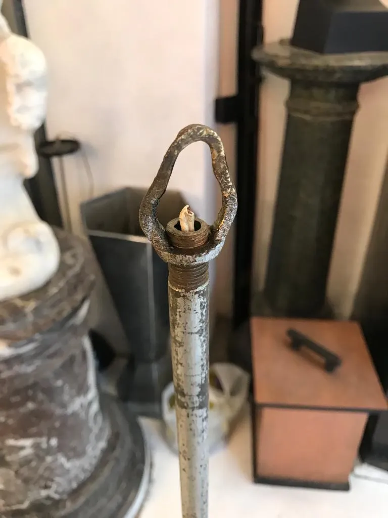 Antique hanging lamp with a unique design in a decorative setting.