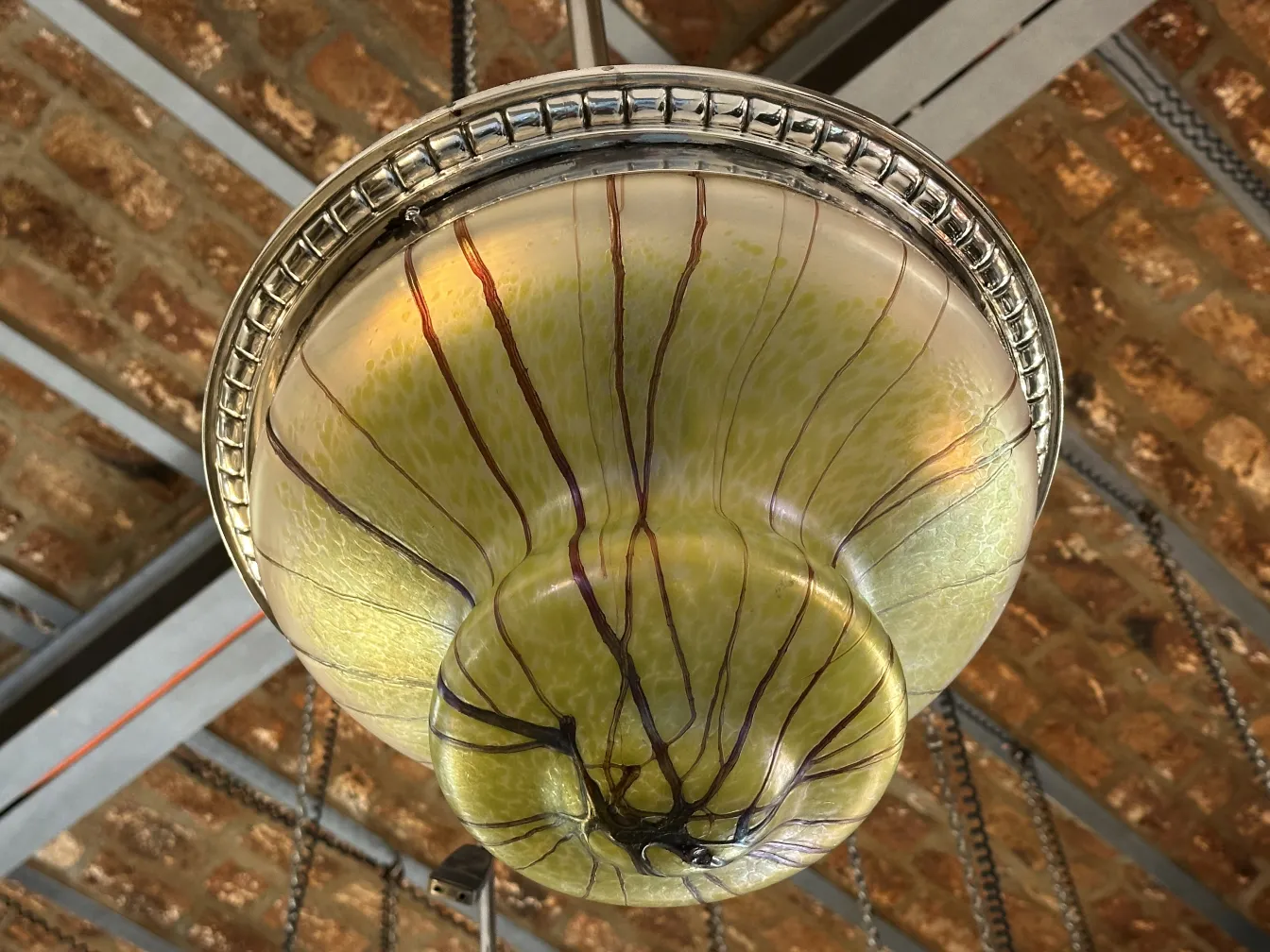 antique hanging lamp with green tones and line designs