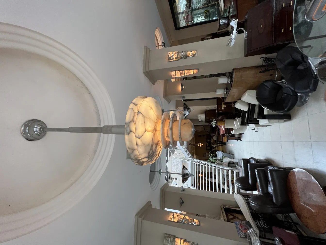Antique alabaster hanging lamp illuminating a living room.