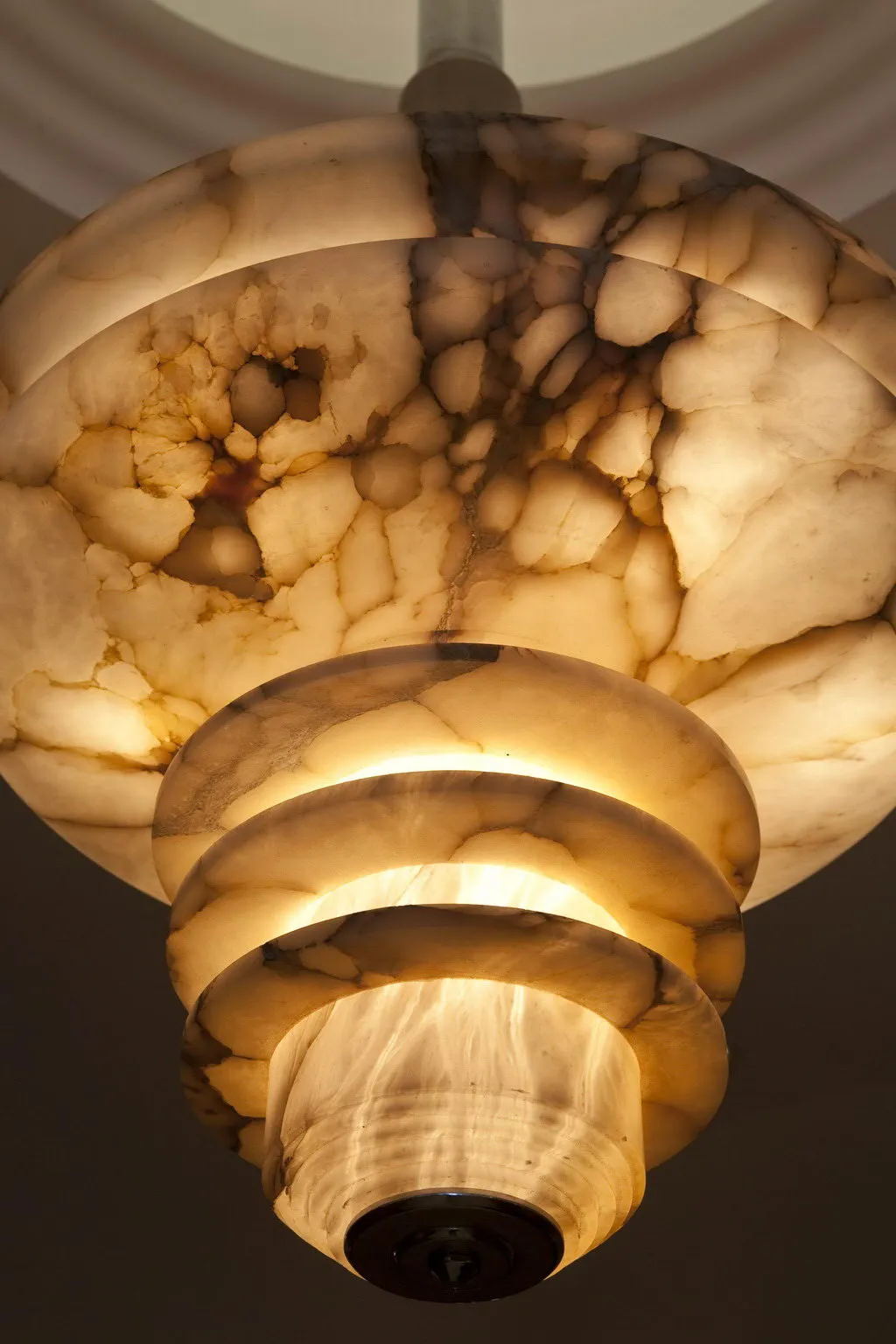 Antique hanging lamp with a unique design in light tones, subtly illuminating the environment.