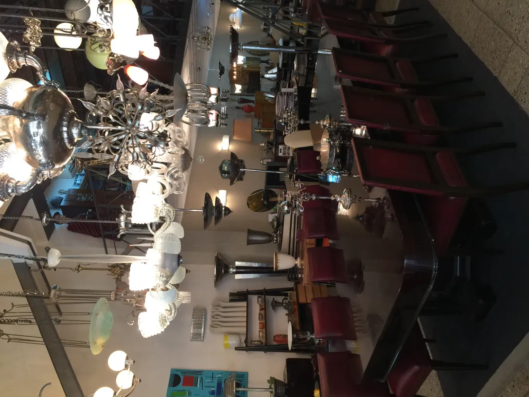 Antique hanging lamp made of glass in a stylish setting with tables and chairs