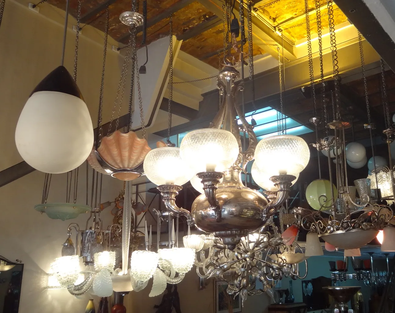 Antique hanging lamp with multiple lights and decorative details in an elegant setting.