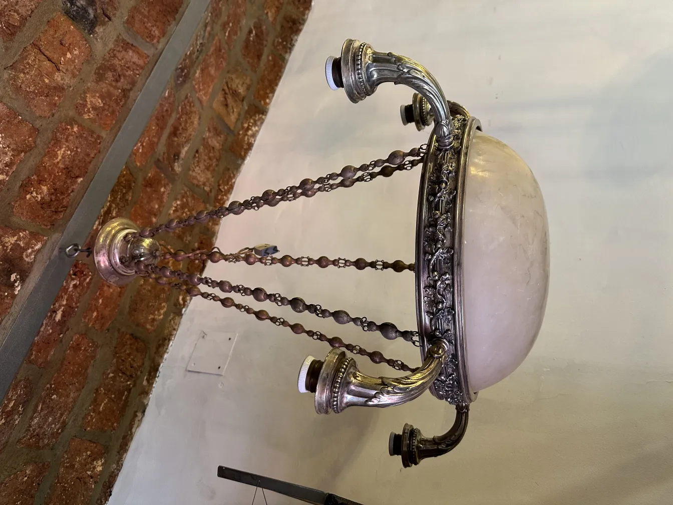 Antique hanging lamp, featuring decorative chains and an elegant base.