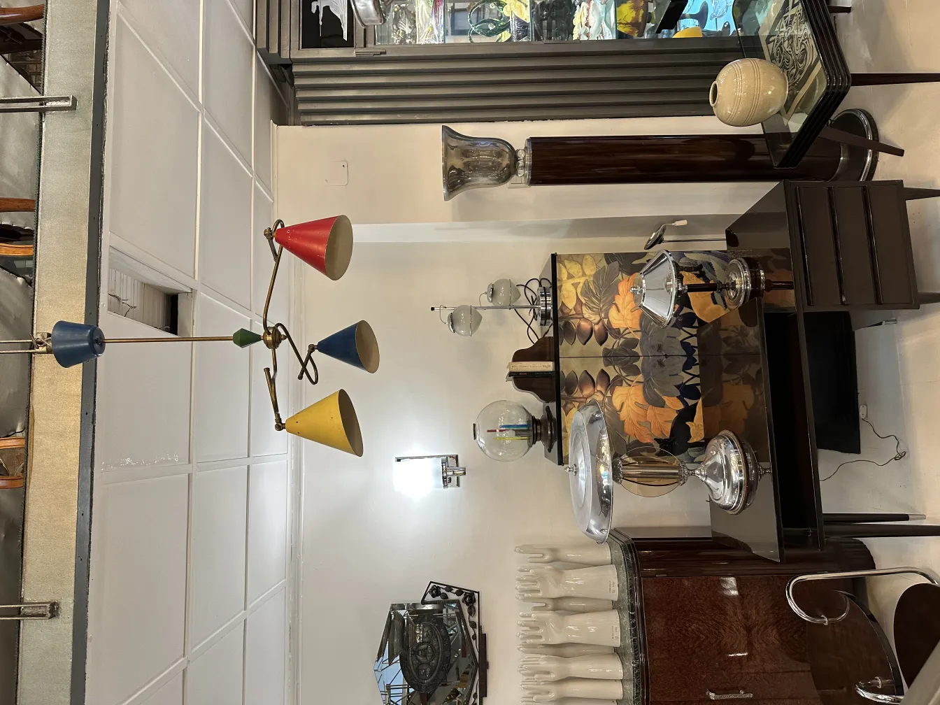 Antique hanging lamp with colorful shades in red, blue, and yellow.