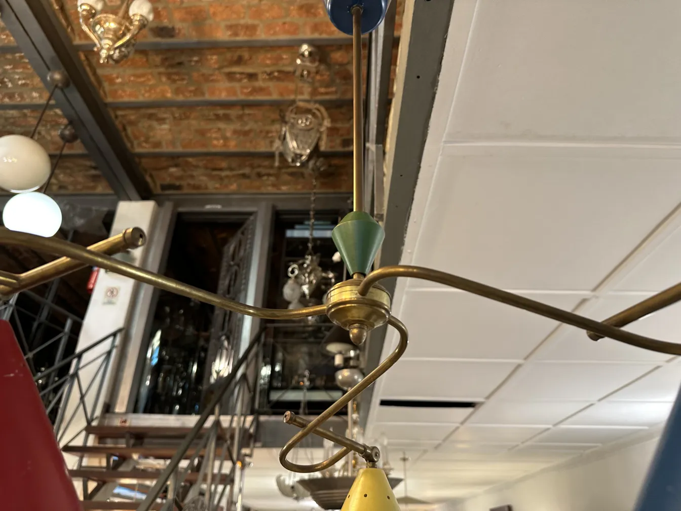 Colorful antique hanging lamp with golden details, in a retro setting.