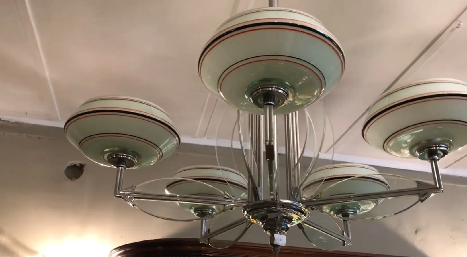 Lustre ancien avec six abat-jours en verre vert et détails décoratifs.