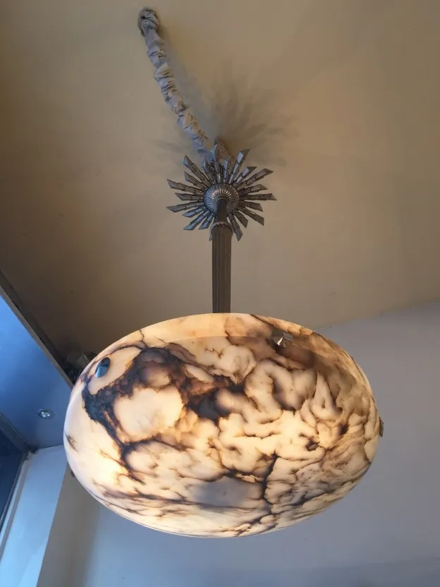 Antique hanging lamp made of alabaster in a cozy setting