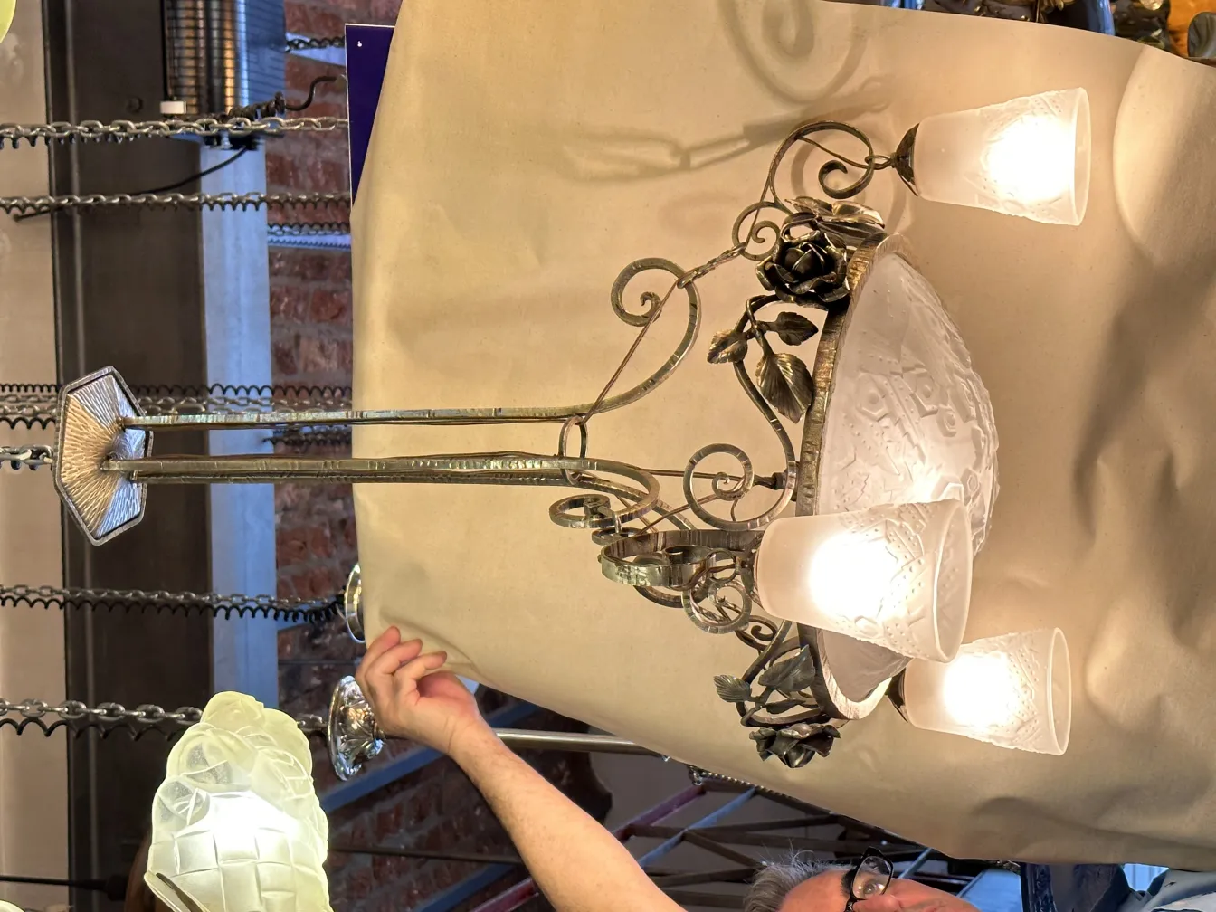 Antique hanging lamp with cool light, rose-shaped details.