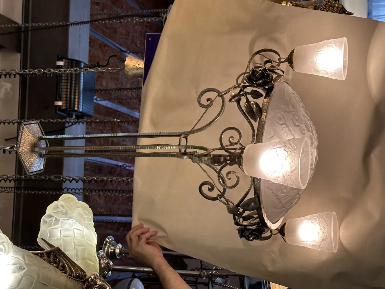 Antique hanging lamp with three glass lights and elegant design.