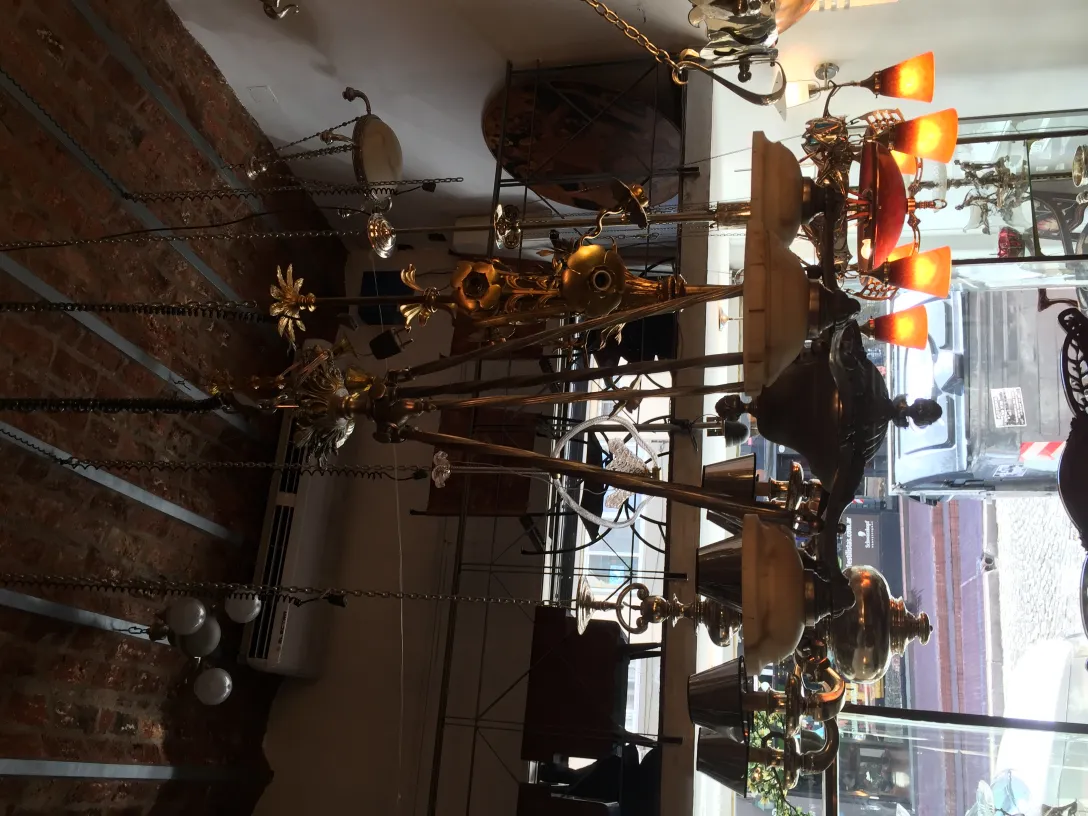 Antique hanging lamp with golden lights in a cozy setting.