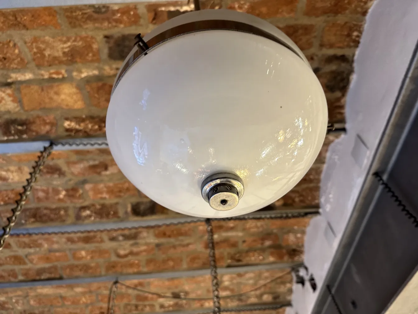 Lâmpada de teto antiga, esfera branca, ambiente acolhedor